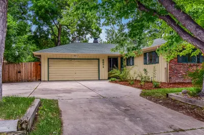 a house with a garage and a driveway at Super Cute Five Bedroom Home in Denver Perfect For Girls Trips in Denver