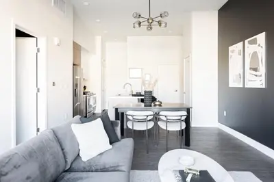 a living room with a gray couch and a table at Relaxed Elegance at Espadin in Denver