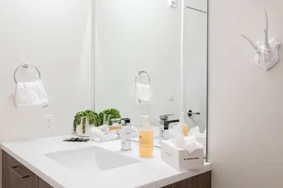 a white bathroom with a sink and a mirror at Relaxed Elegance at Espadin in Denver