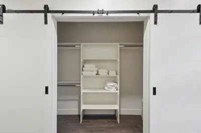 a closet with white walls and white shelves at Southwestern Charm Studio at Espadin in Denver