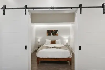 a bedroom with a bed through a sliding door at Southwestern Charm Studio at Espadin in Denver