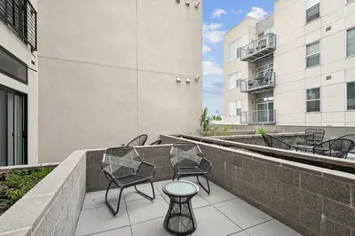 a patio with chairs and a table on a building at Southwestern Charm Studio at Espadin in Denver
