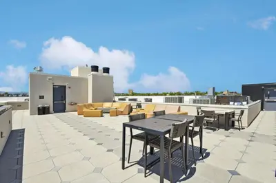 a patio with a table and chairs on a roof at Southwestern Charm Studio at Espadin in Denver