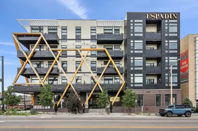a building with a large metal structure on the side of it at Southwestern Charm Studio at Espadin in Denver