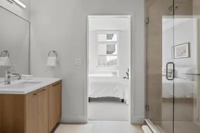 a bathroom with a shower and a sink and a bed at Art Inspired Retreat at Espadin in Denver