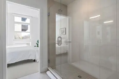 a bathroom with a shower with a glass door at Art Inspired Retreat at Espadin in Denver