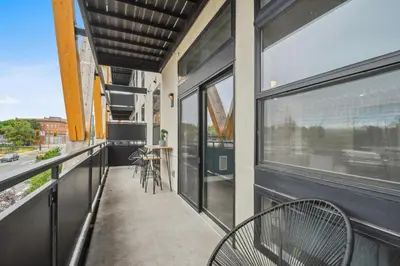 a balcony with a table and chairs and windows at Sleek & Chic Comforts at Espadin in Denver