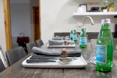 a table with towels and a green bottle of water at Luxury 2 bed 2 bath Condo in River Run with Pool and Hot Tub in Keystone