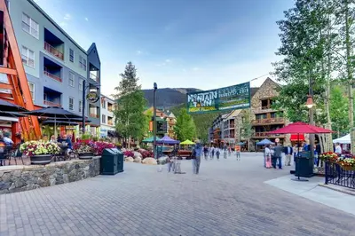 a street in a town with people walking around at Luxury 2 bed 2 bath Condo in River Run with Pool and Hot Tub in Keystone