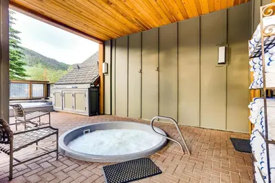 a hot tub on the patio of a house at Luxury 2 bed 2 bath Condo in River Run with Pool and Hot Tub in Keystone