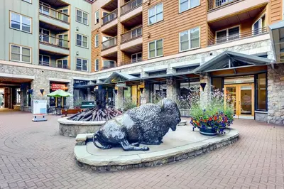 a statue of a bear sitting in front of a building at Luxury 2 bed 2 bath Condo in River Run with Pool and Hot Tub in Keystone