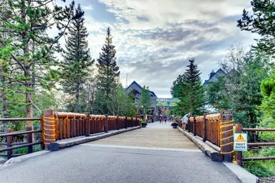 a bridge over a road with a wooden fence at Luxury 2 bed 2 bath Condo in River Run with Pool and Hot Tub in Keystone