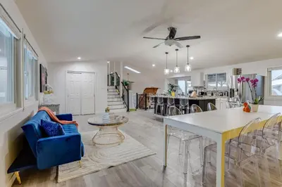 a kitchen and living room with a table and chairs at Pop Art Oasis with Karaoke Mini Golf Hot Tub and Pool in Arvada