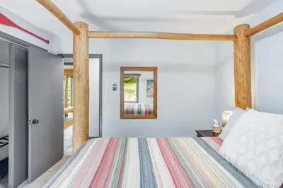 a bedroom with a bed with a wooden frame at The Evergreen Oasis I Red Rocks I Morrison in Morrison