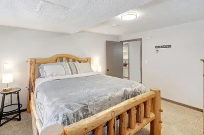 a bedroom with a wooden bed in a room at The Evergreen Oasis I Red Rocks I Morrison in Morrison