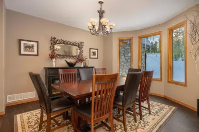 a dining room with a table and chairs and a mirror at Stunning Mountain Retreat with View and Private Hot Tub in Tabernash