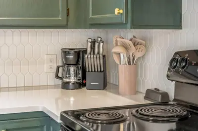 a kitchen counter with a coffee maker and utensils at Central Denver Hangout with Huge Backyard in Denver