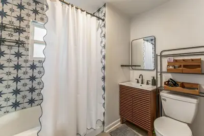 a bathroom with a shower curtain and a toilet at Central Denver Hangout with Huge Backyard in Denver