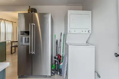 a kitchen with a stainless steel refrigerator with a microwave at Central Denver Hangout with Huge Backyard in Denver