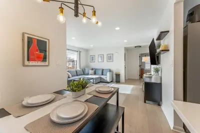 a living room with a table and a couch at Central Denver Hangout with Huge Backyard in Denver