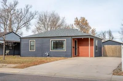 a gray house with a red garage at Central Denver Hangout with Huge Backyard in Denver