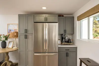 a kitchen with a stainless steel refrigerator at The Wild Rose Gatehouse in Arvada