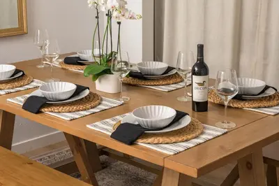 a wooden table with a bottle of wine and glasses at The Wild Rose Gatehouse in Arvada