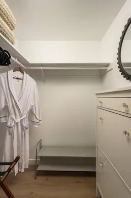 a room with a closet with a dresser and a robe at The Wild Rose Gatehouse in Arvada