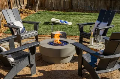 two chairs and a fire pit in a yard at The Wild Rose Gatehouse in Arvada