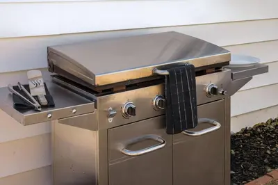 a stainless steel barbecue grill sitting next to a wall at The Wild Rose Gatehouse in Arvada