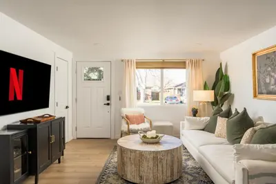 a living room with a couch and a tv at The Wild Rose Gatehouse in Arvada