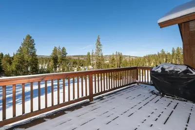 a large deck with a view of the water at Wagon Ranch Ultimate Retreat with Hot Tub in Tabernash