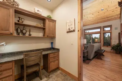 a kitchen with a counter and a dining room at Wagon Ranch Ultimate Retreat with Hot Tub in Tabernash