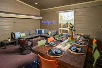 a living room with a table and a couch at The Ultimate Hangout House in Denver