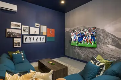 a living room with a tv on a wall at The Ultimate Hangout House in Denver