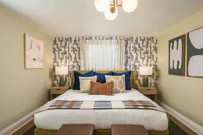 a bedroom with a large bed with blue accents at The Ultimate Hangout House in Denver