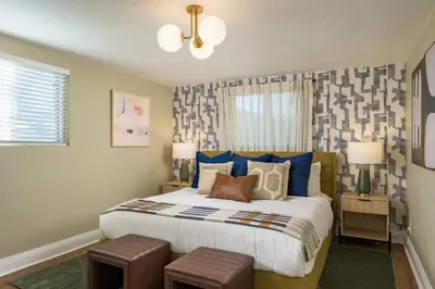 a bedroom with a large bed with blue pillows at The Ultimate Hangout House in Denver