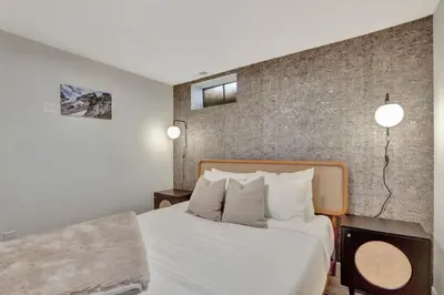 a bedroom with a bed and a brick wall at Brand New Arvada Guest Suite Sauna Fire Pit in Arvada