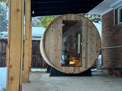 a large wooden circle on the side of a house at Brand New Arvada Guest Suite Sauna Fire Pit in Arvada