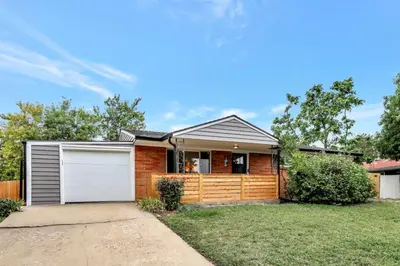 a brick house with a white garage at Brand New Arvada Guest Suite Sauna Fire Pit in Arvada