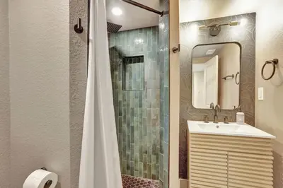 a bathroom with a shower and a sink and a mirror at Brand New Arvada Guest Suite Sauna Fire Pit in Arvada