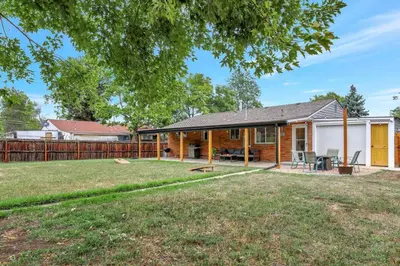 a home with a fence and a yard at Brand New Arvada Guest Suite Sauna Fire Pit in Arvada