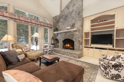 a living room with a fireplace and a tv at Trailside Mountain Retreat with Private Hot Tub in Winter Park