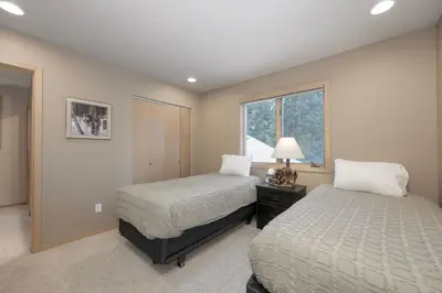a bedroom with two beds and a window at Trailside Mountain Retreat with Private Hot Tub in Winter Park