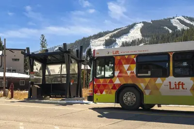 a bus parked at a bus stop in the mountains at Trailside Mountain Retreat with Private Hot Tub in Winter Park