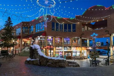 a building with christmas lights in front of it at Trailside Mountain Retreat with Private Hot Tub in Winter Park