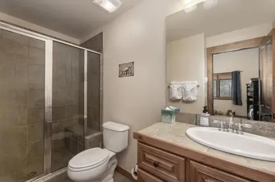 a bathroom with a toilet and a sink and a shower at Hot Tub Mountain Views Steps to Trails in Winter Park