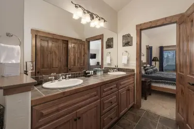 a bathroom with two sinks and a large mirror at Hot Tub Mountain Views Steps to Trails in Winter Park