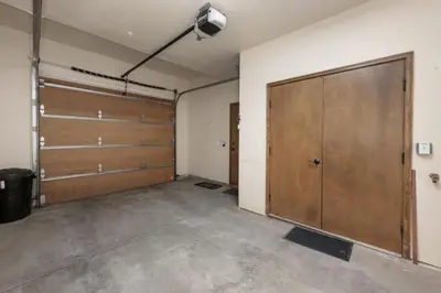 a garage with two sliding doors and a large door at Hot Tub Mountain Views Steps to Trails in Winter Park