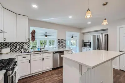 a kitchen with white cabinets and a white counter top at Charming Family Friendly 4bd 2ba Arvada Home in Arvada